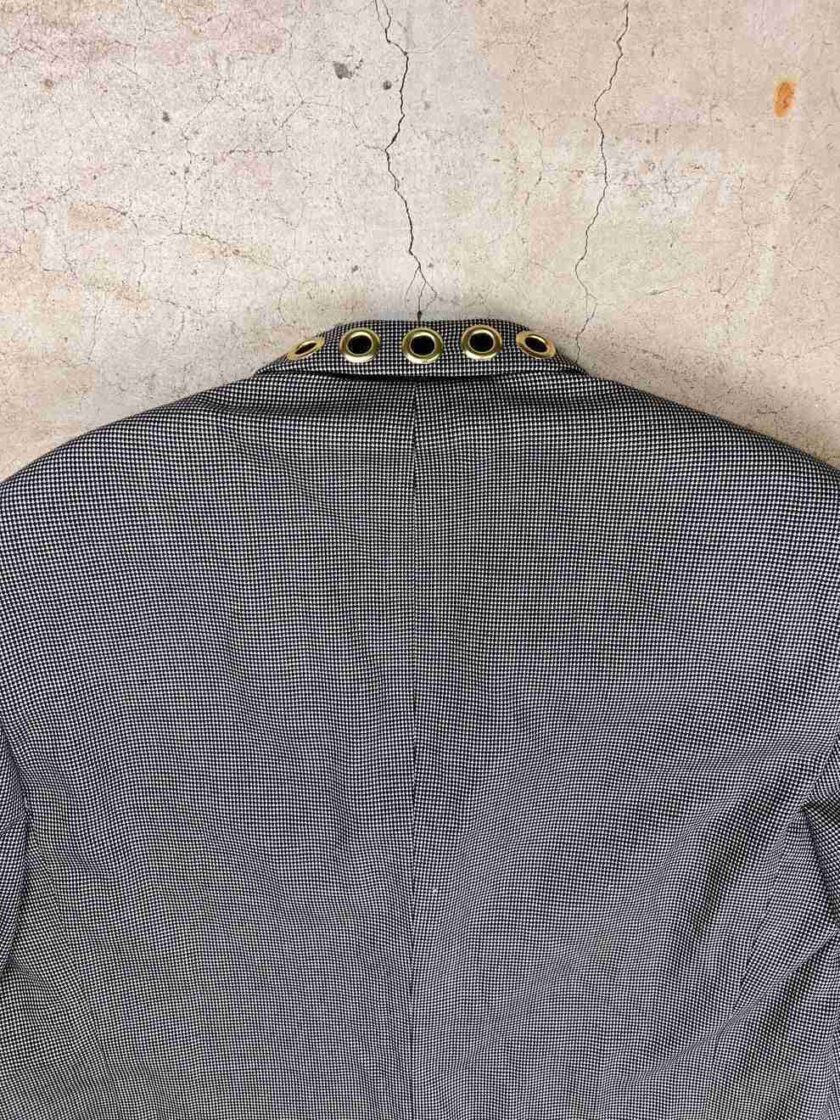 the back of a gray shirt with gold buttons.