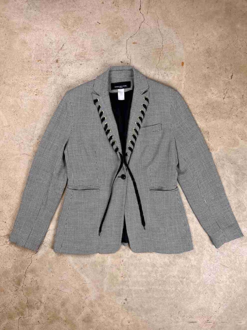 a gray jacket with black laces on it.