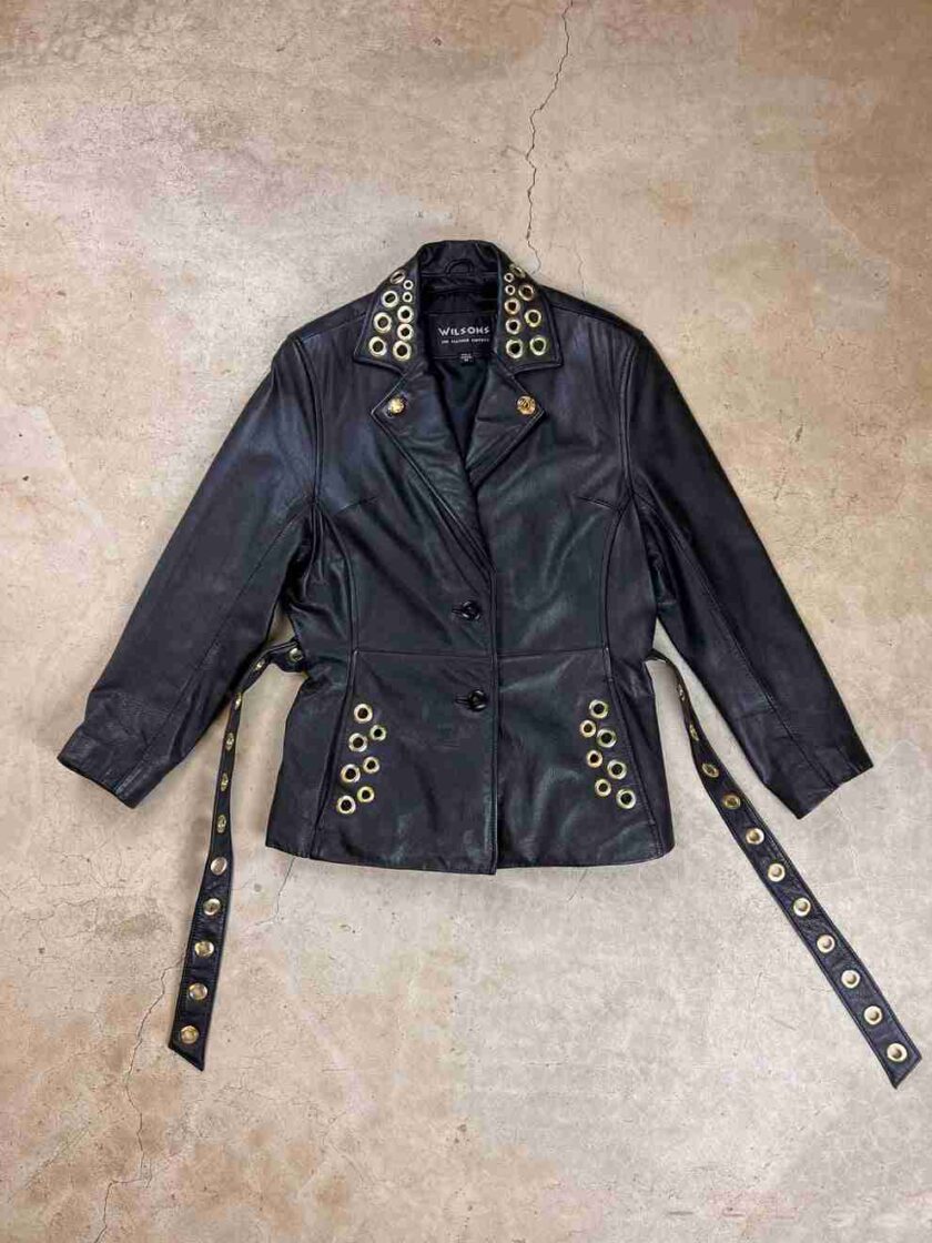 a black leather jacket with gold studs and a belt.