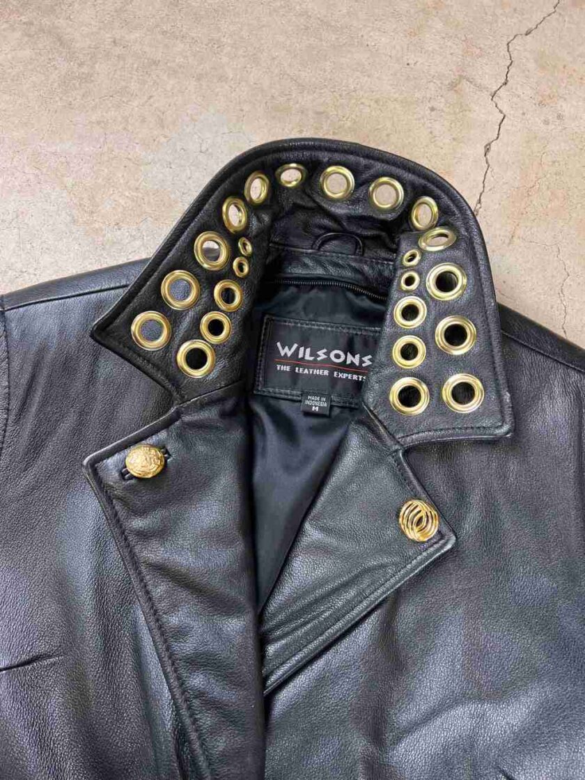 a black leather jacket with gold rivets on it.