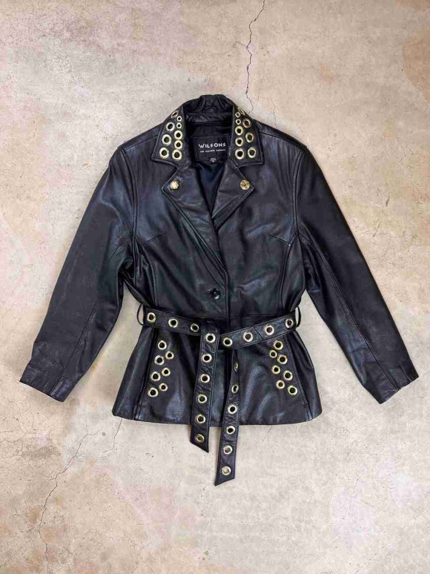a black leather jacket with gold buttons and a belt.