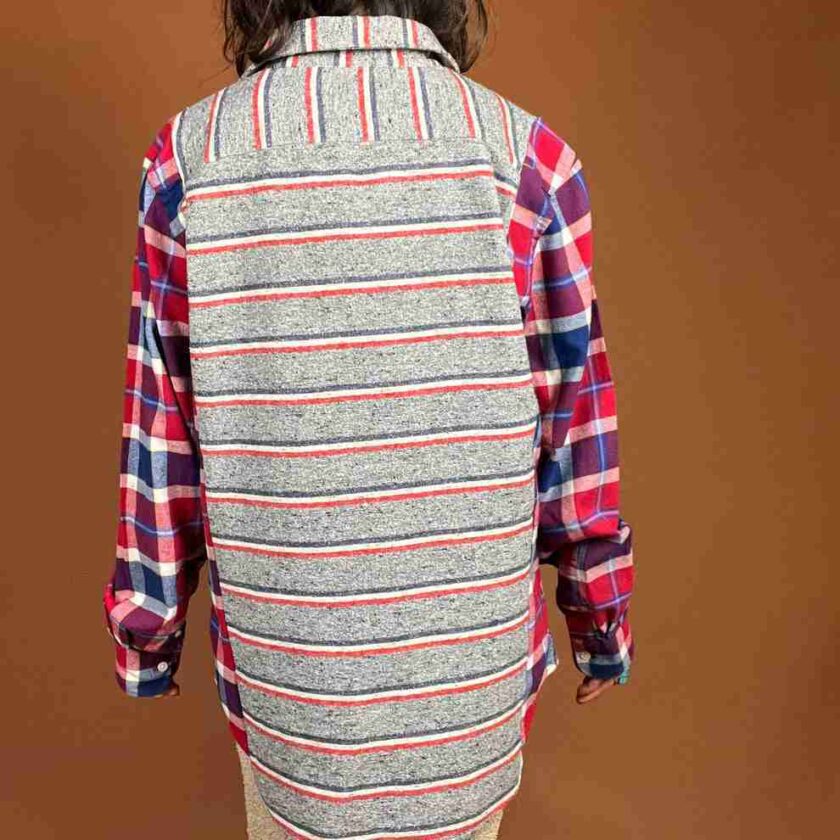 the back of a woman wearing a plaid shirt.