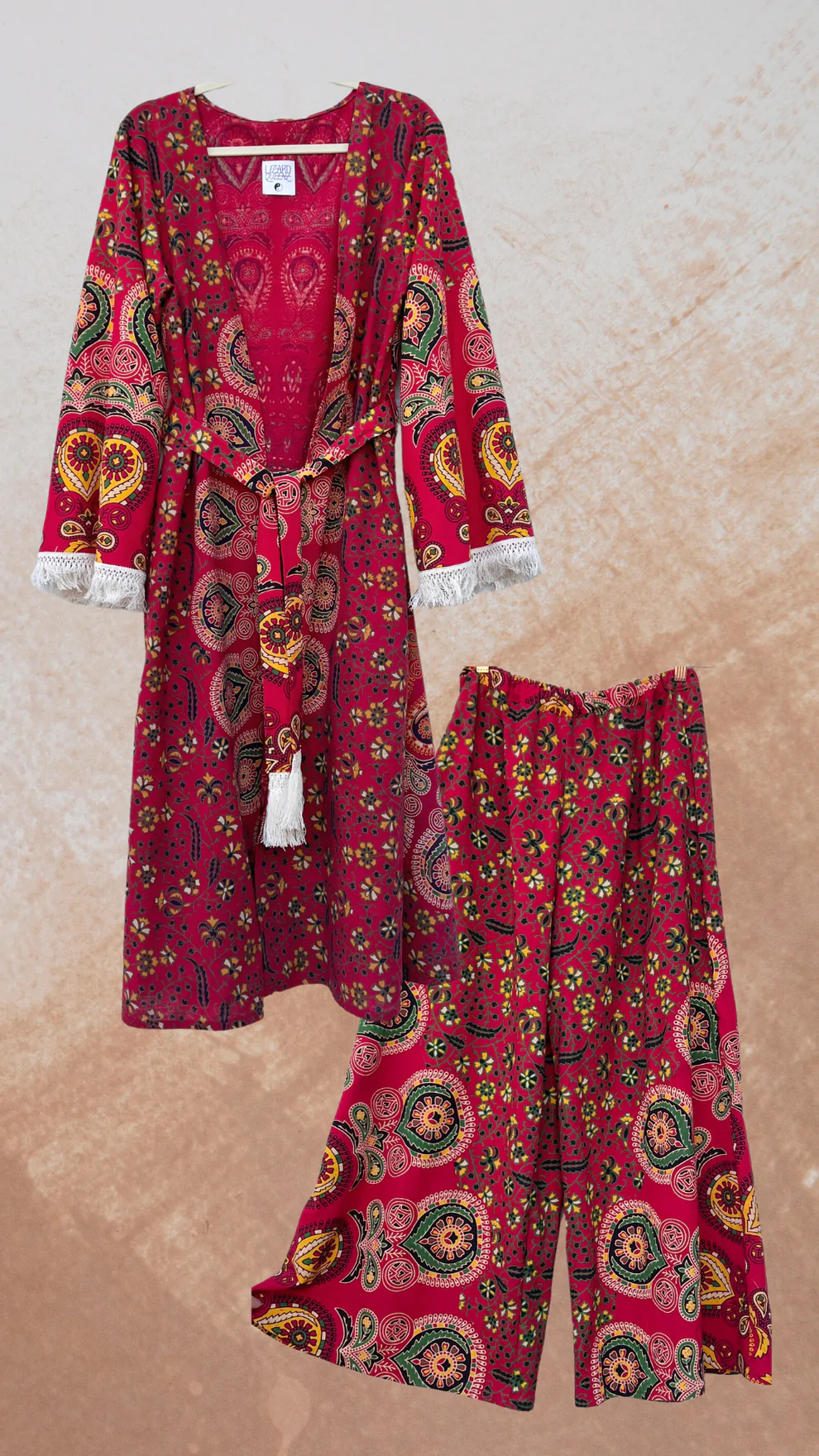 A women's Peacock Mandala Duster Kimono in red with a floral pattern.