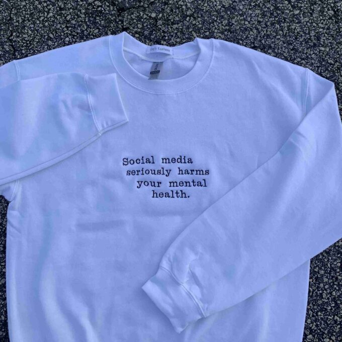 a white sweatshirt with a quote on it.