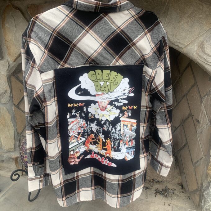 A Green Day flannel shirt with a picture of a dragon on it.
