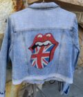 A Rolling Stones denim jacket with the British flag on it.