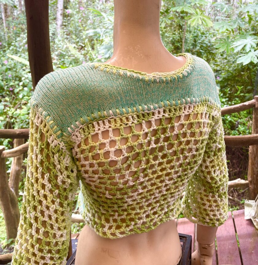 A mannequin wearing a green and yellow Fairy sweater.