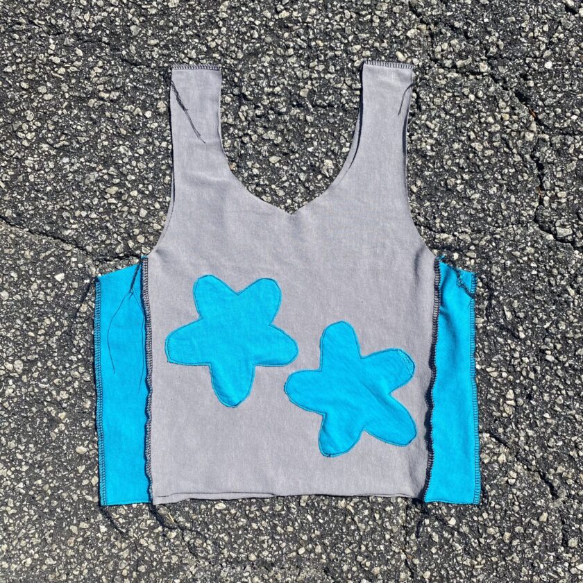 a gray and blue flower tank top sitting on the ground.