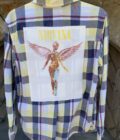 a Nirvana Yellow Flannel Long Sleeve Shirt with a picture of a woman on it.