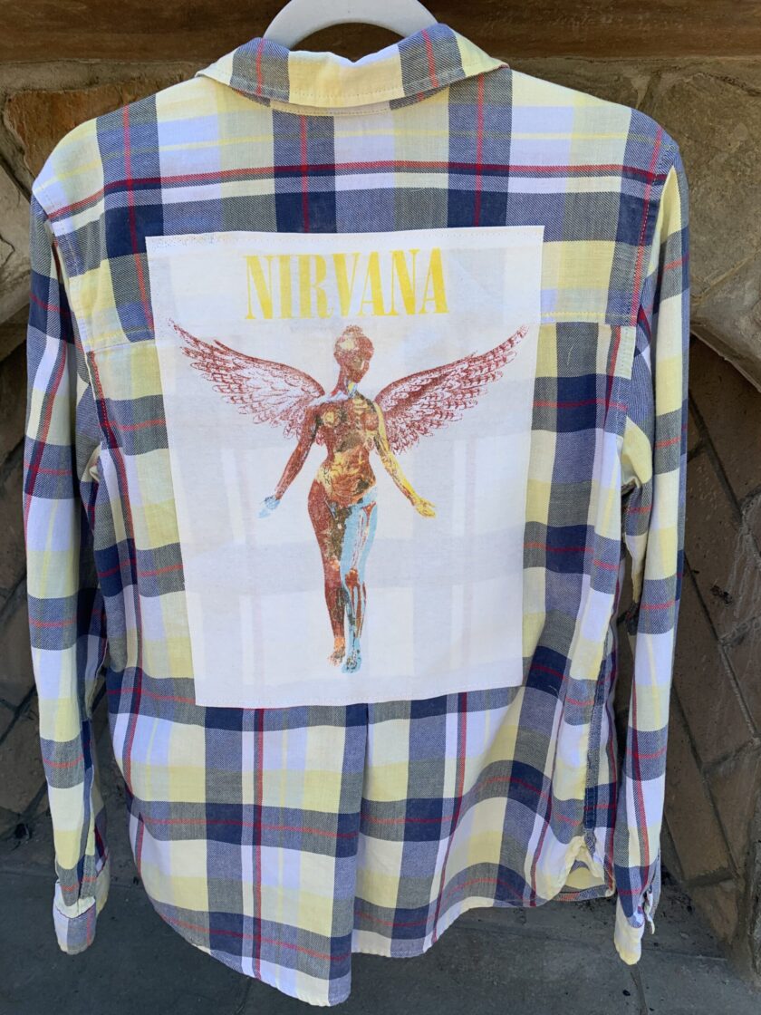 a Nirvana Yellow Flannel Long Sleeve Shirt with a picture of a woman on it.