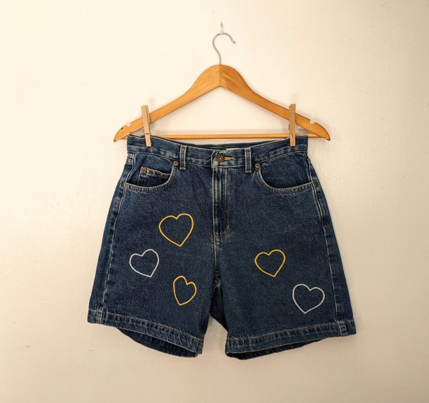 A pair of Embroidered Heart Shorts.