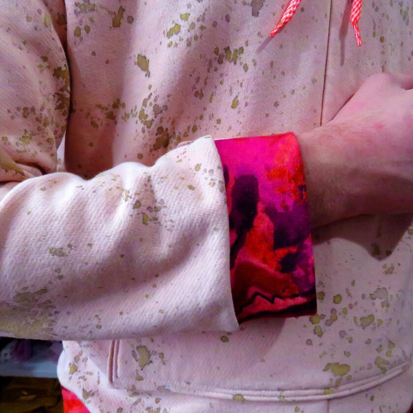 A close up of a person wearing a Rusty Pink Hoodie (Large).
