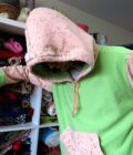 a person in a Green and Rusty Pink Hoodie (2X-Large) in a closet.