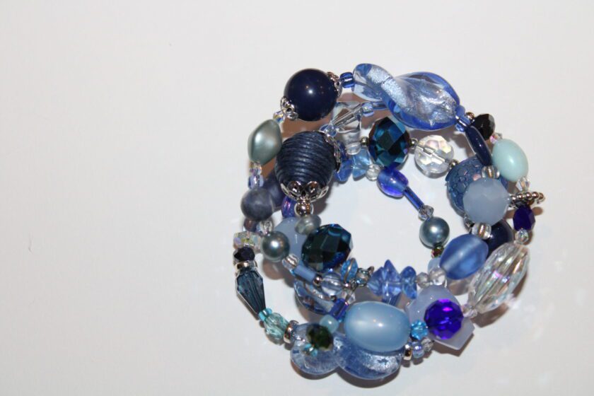 a close up of a blue bracelet on a table.