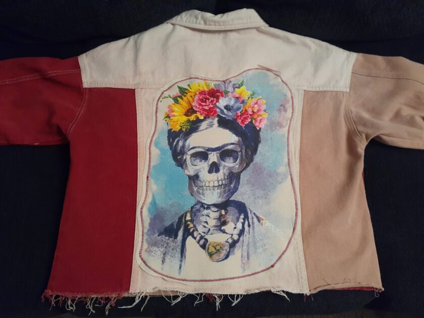 a Skull & Flowers Frida Kahlo inspired pink color block denim jacket Large