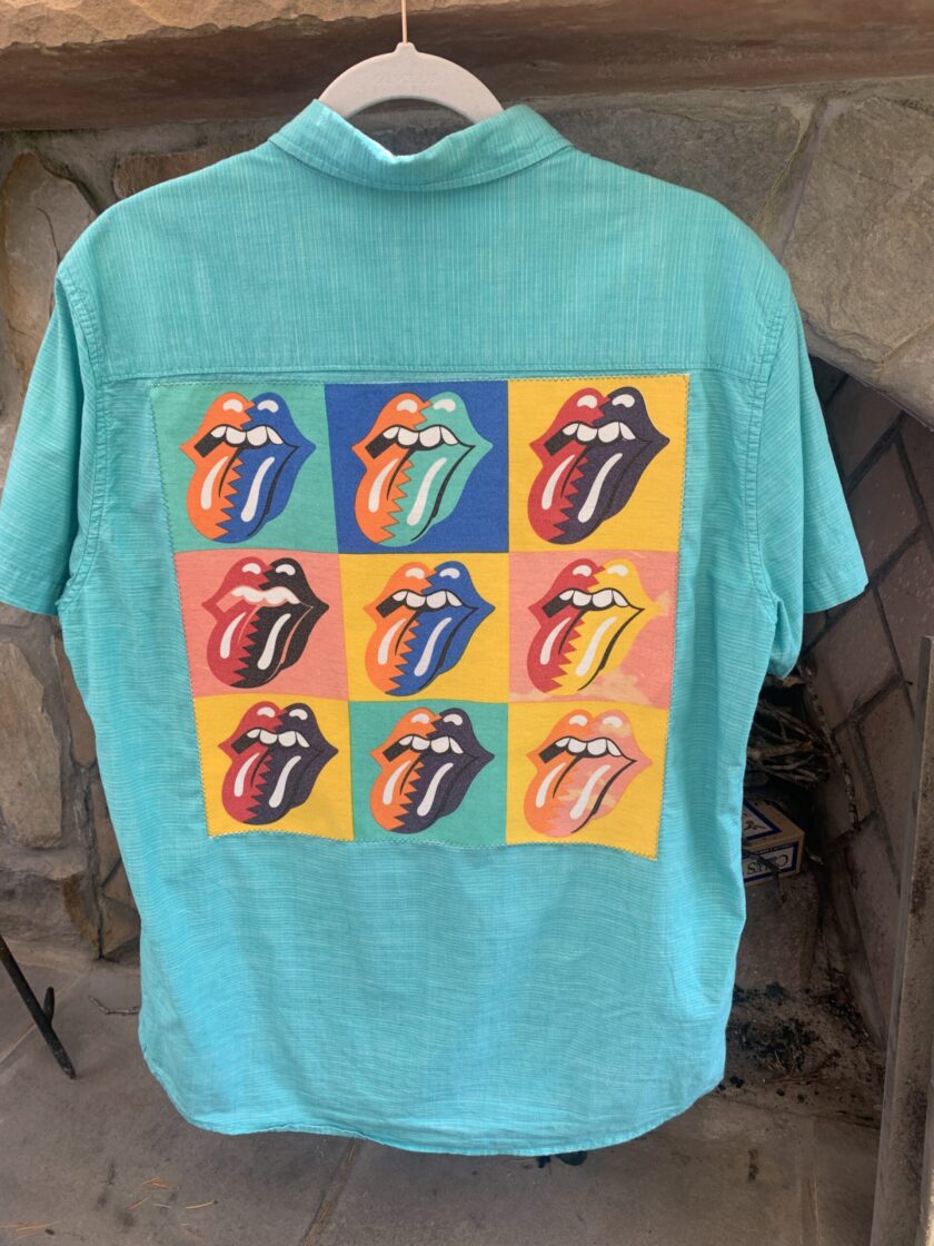 A Rolling Stones logo aqua button up shirt with the band's picture on it.