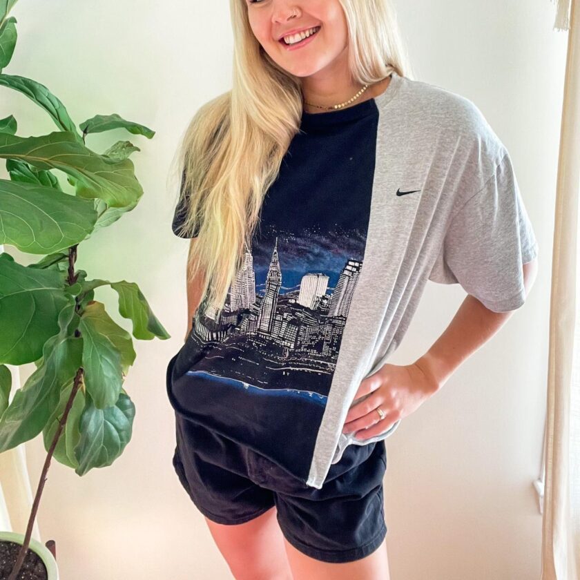 a woman standing in front of a Vintage Nike Reworked Cityscape Skyline Split Tee.