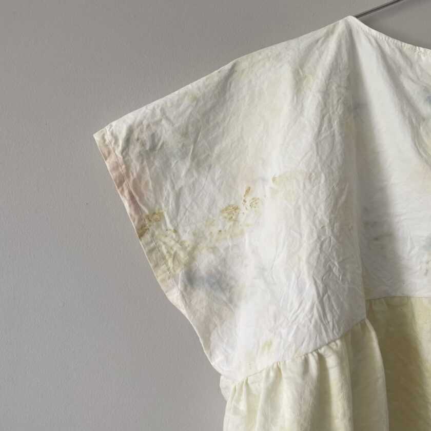 A Yellow Tie-dyed Babydoll Crop Top hanging on a clothes line.