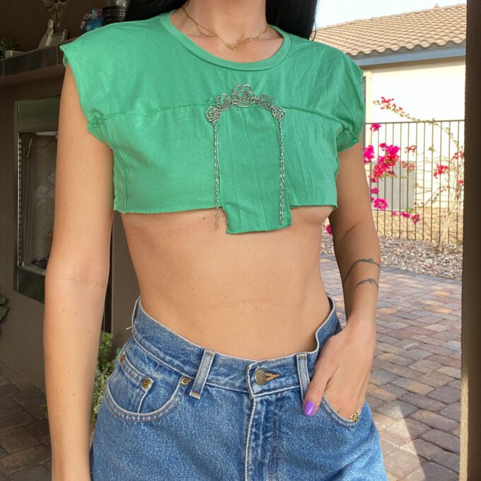 A woman wearing a 1of1 floral mint micro crop top and jeans.