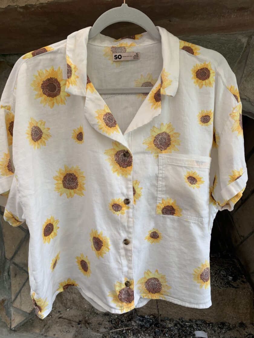 A white All You Need Is Love - Sunflower button up shirt.