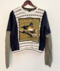 A Neutral Duck & Carhartt Grandpa Sweater Rework with a bird on it hanging on a wall.