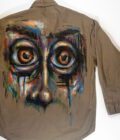 A Wide-Eyes Button-Down Shirt with a picture of a face painted on it.