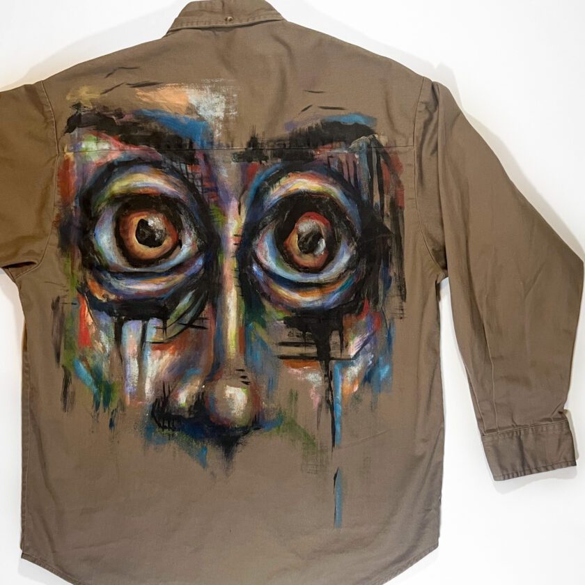 A Wide-Eyes Button-Down Shirt with a picture of a face painted on it.