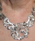 picture of silver tone free form segmented necklace worn with pearls
