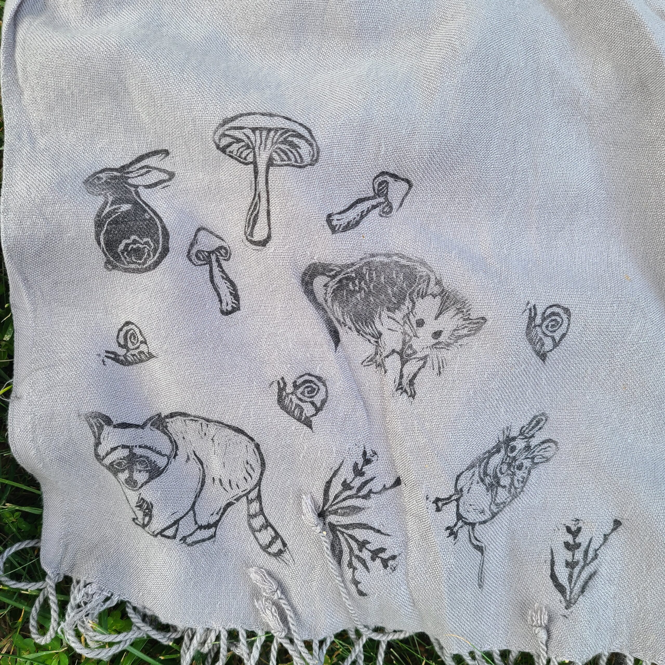 a towel with a picture of cats and mushrooms on it.