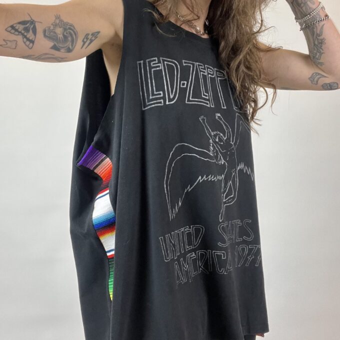 a woman with long hair wearing a tank top.