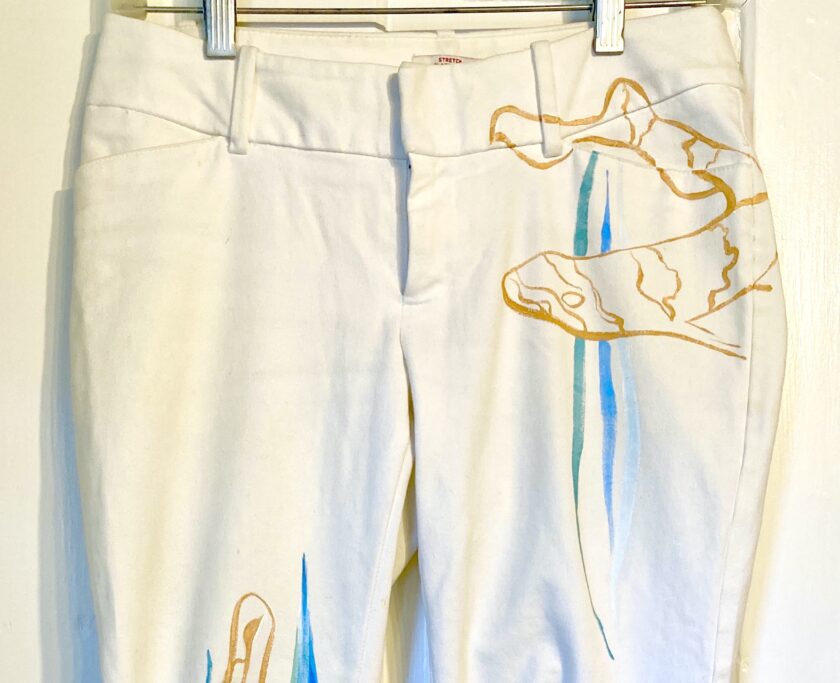 a pair of white pants with a picture of a cow on it.