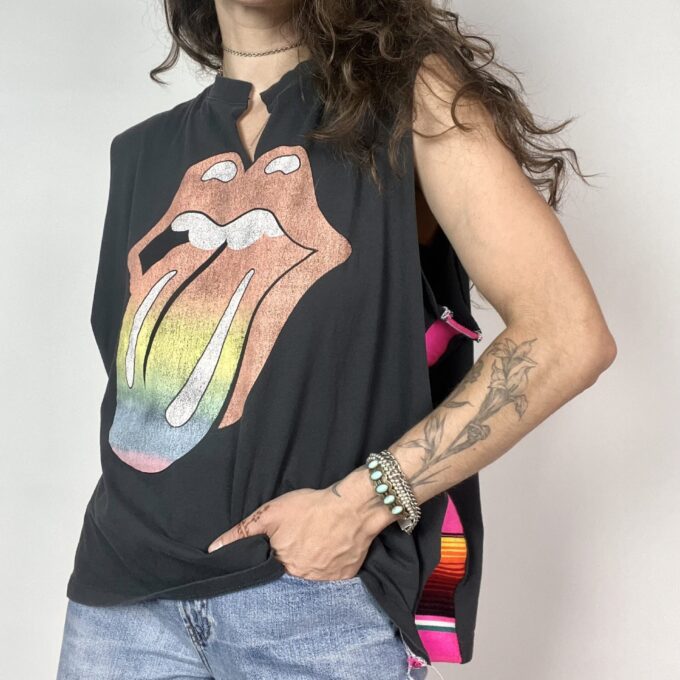 a woman with long hair wearing a black shirt with the rolling stones on it.