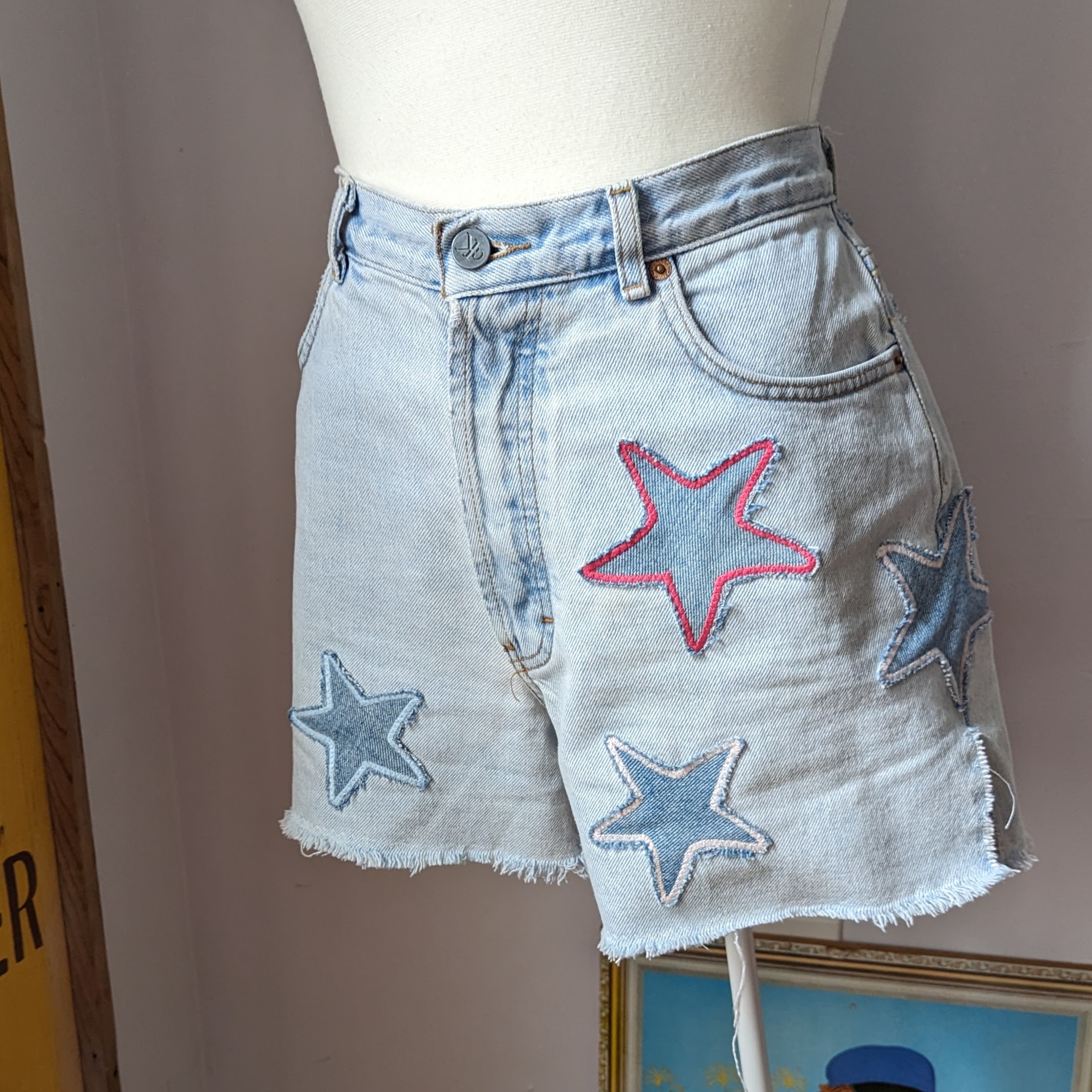 a white mannequin wearing a pair of shorts with stars on them.