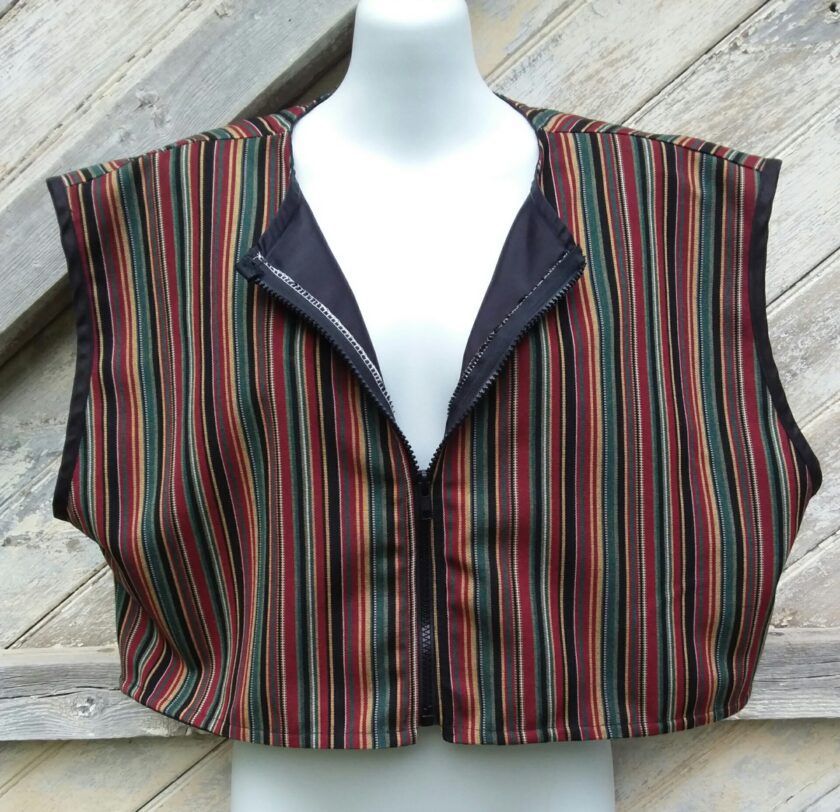 An upcycled vest of striped fabric on a mannequin