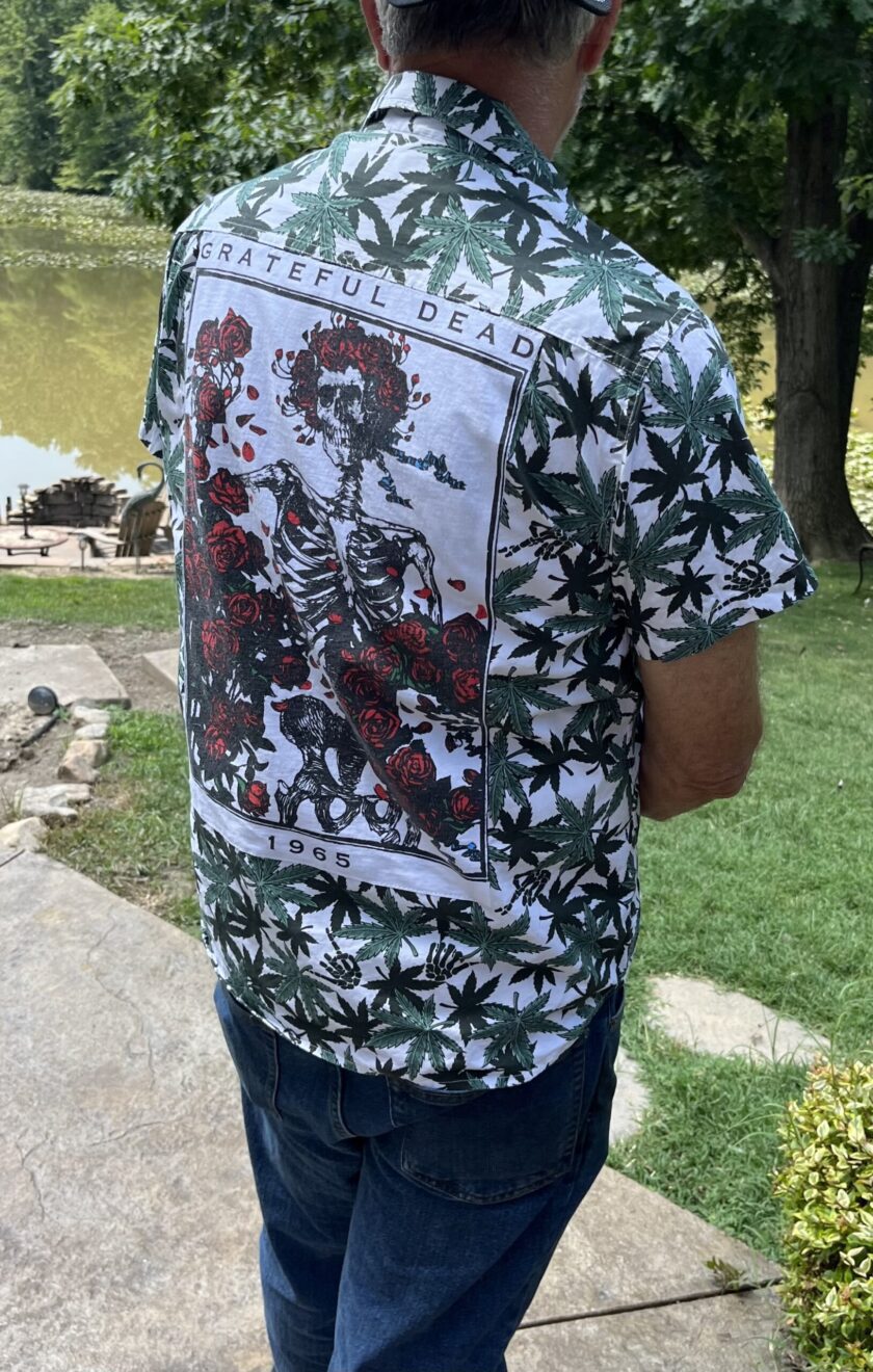 the back of a man wearing a shirt with flowers on it.