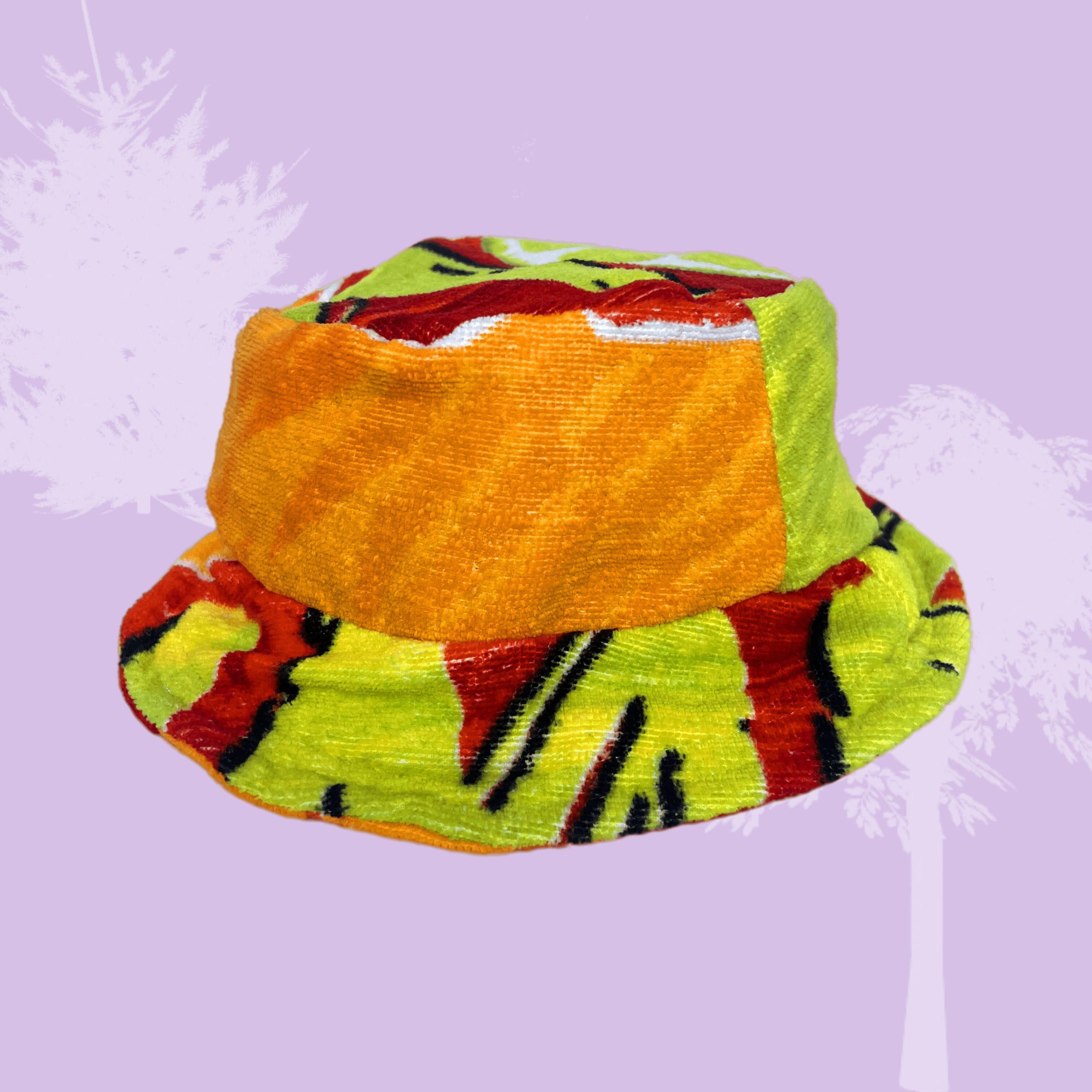 an orange and yellow bucket hat on a purple background.
