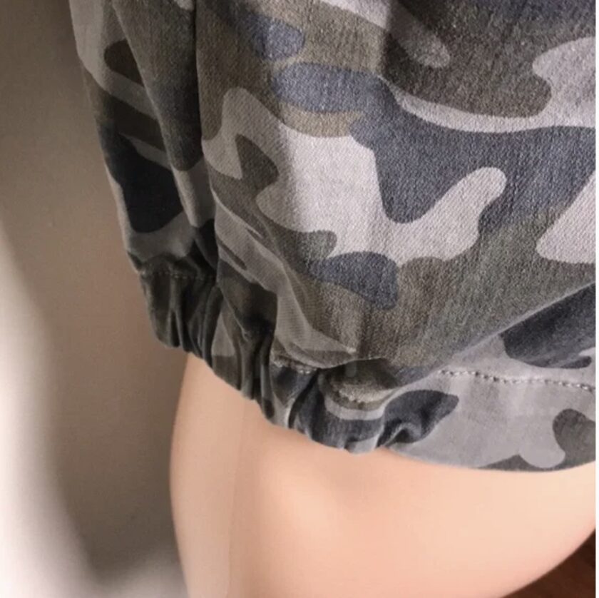 a mannequin wearing a camouflage top.
