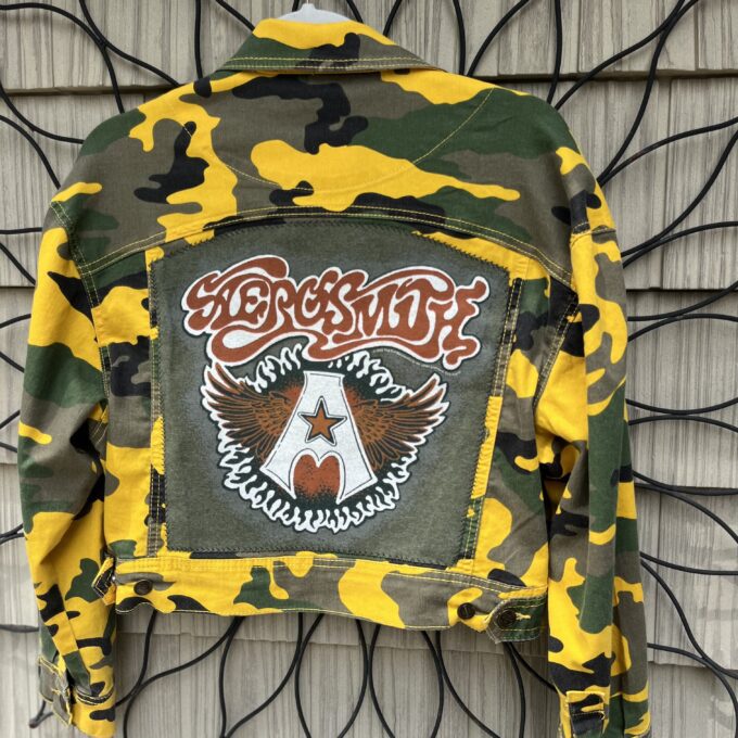 a camouflage jacket hanging on a wall.