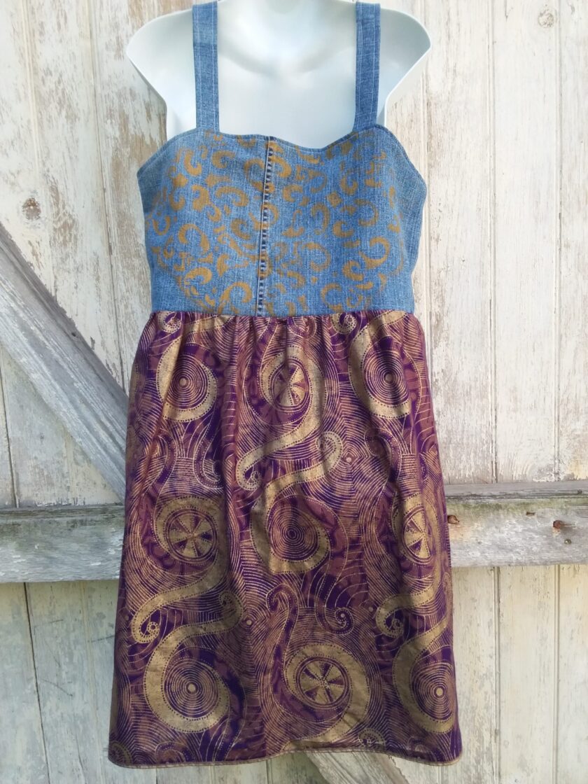 a denim dress with a purple and gold pattern.
