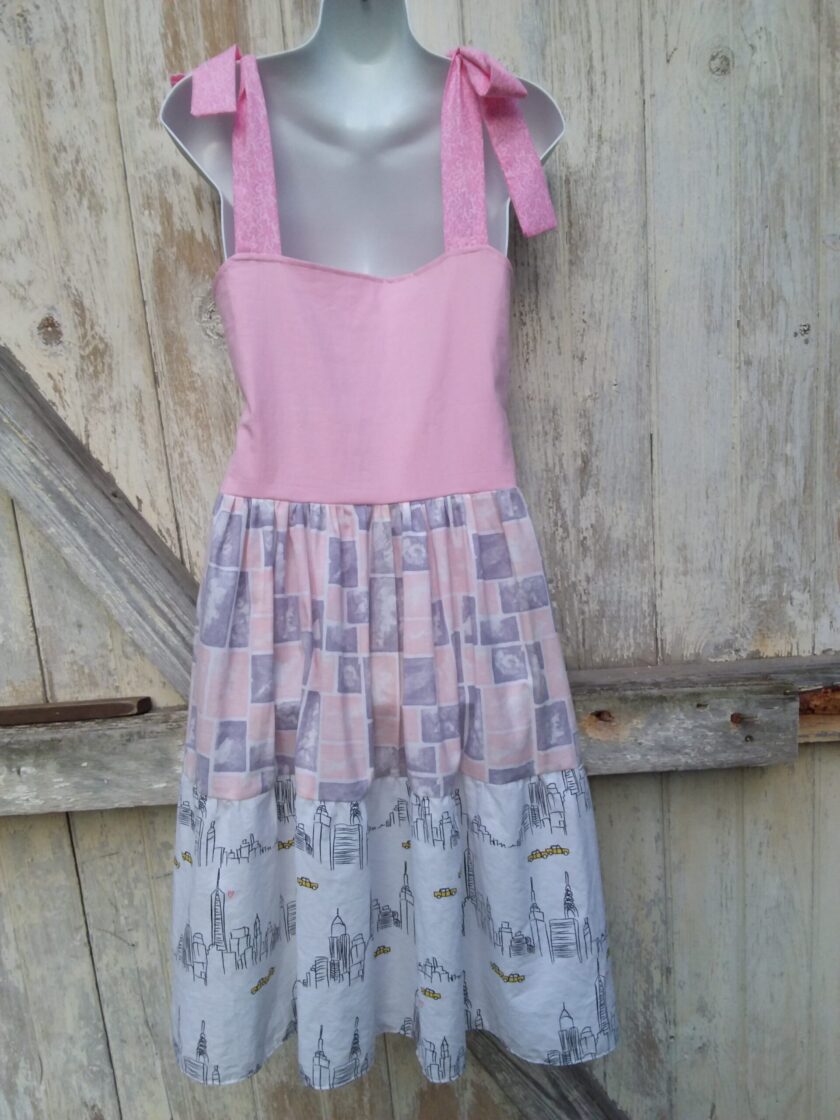 Upcycled dress of pink white and city scape fabrics