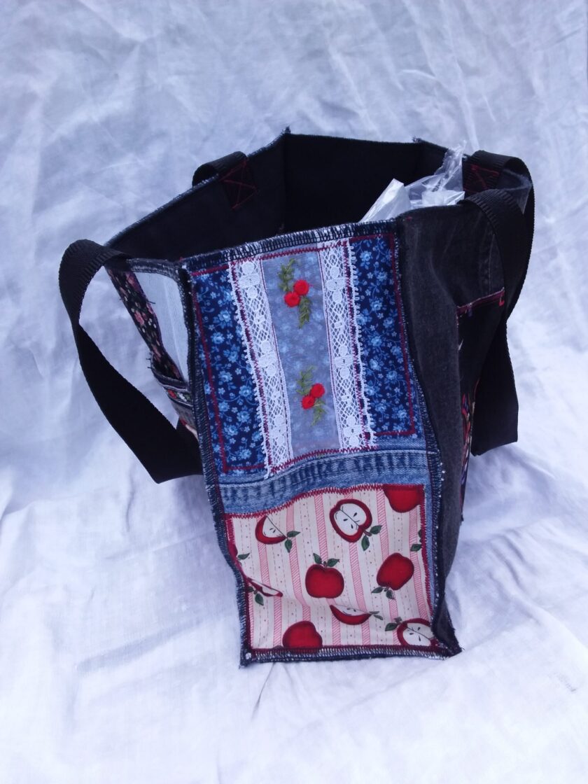A reusable tote bag with a patchwork pattern on it.