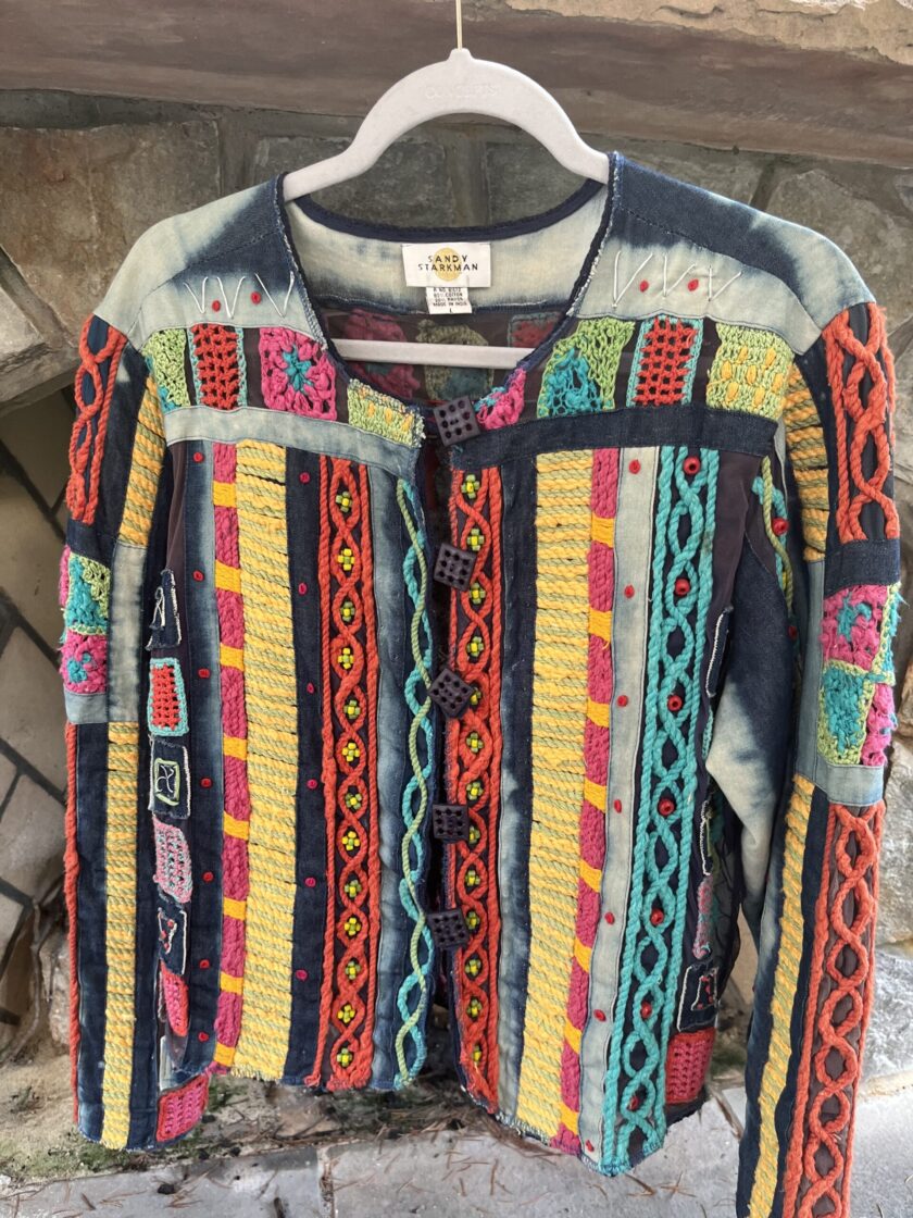 A colorful jacket hanging on a hanger.