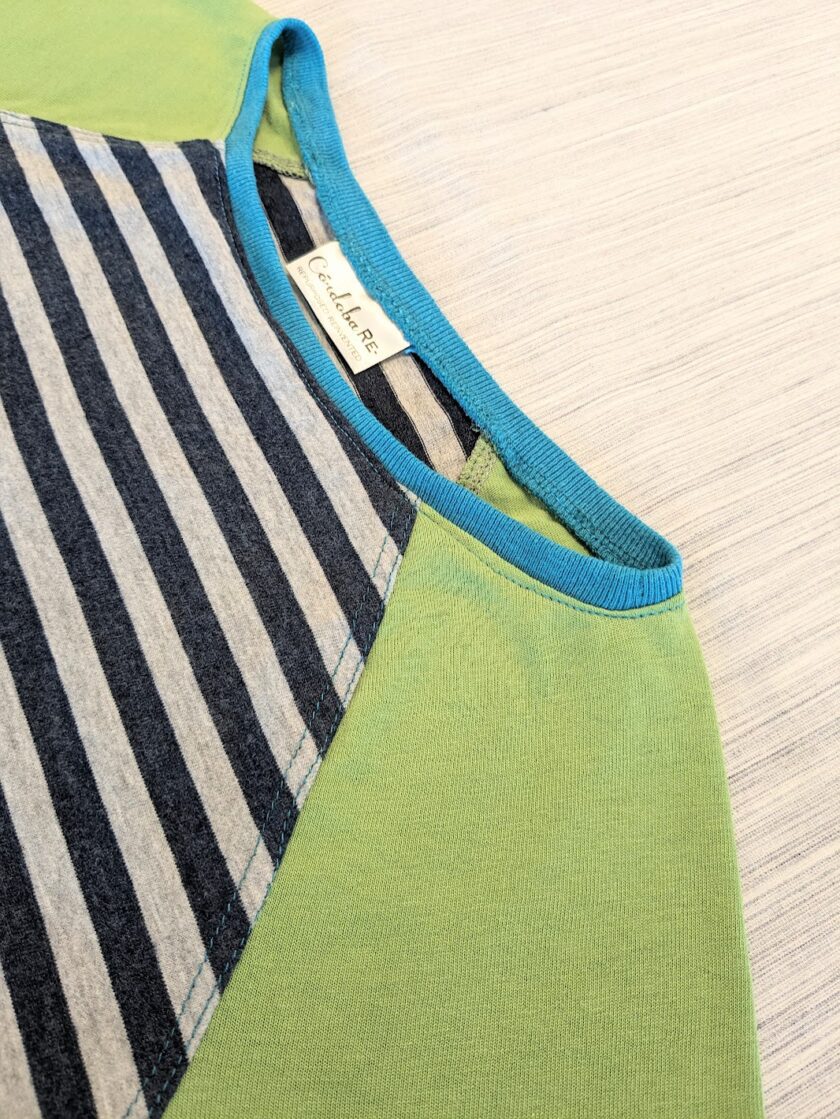 A close up of a green and blue striped t - shirt.