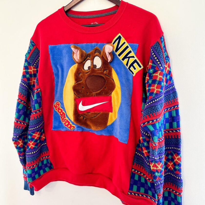 A nike sweater with a scooby dog on it.