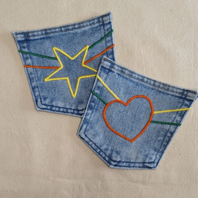A pair of jeans with a star and heart embroidered on them.