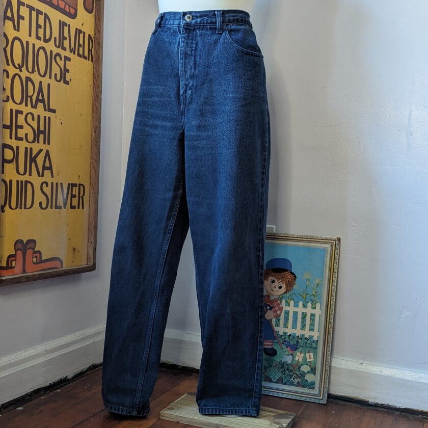 A mannequin wearing a pair of blue jeans.