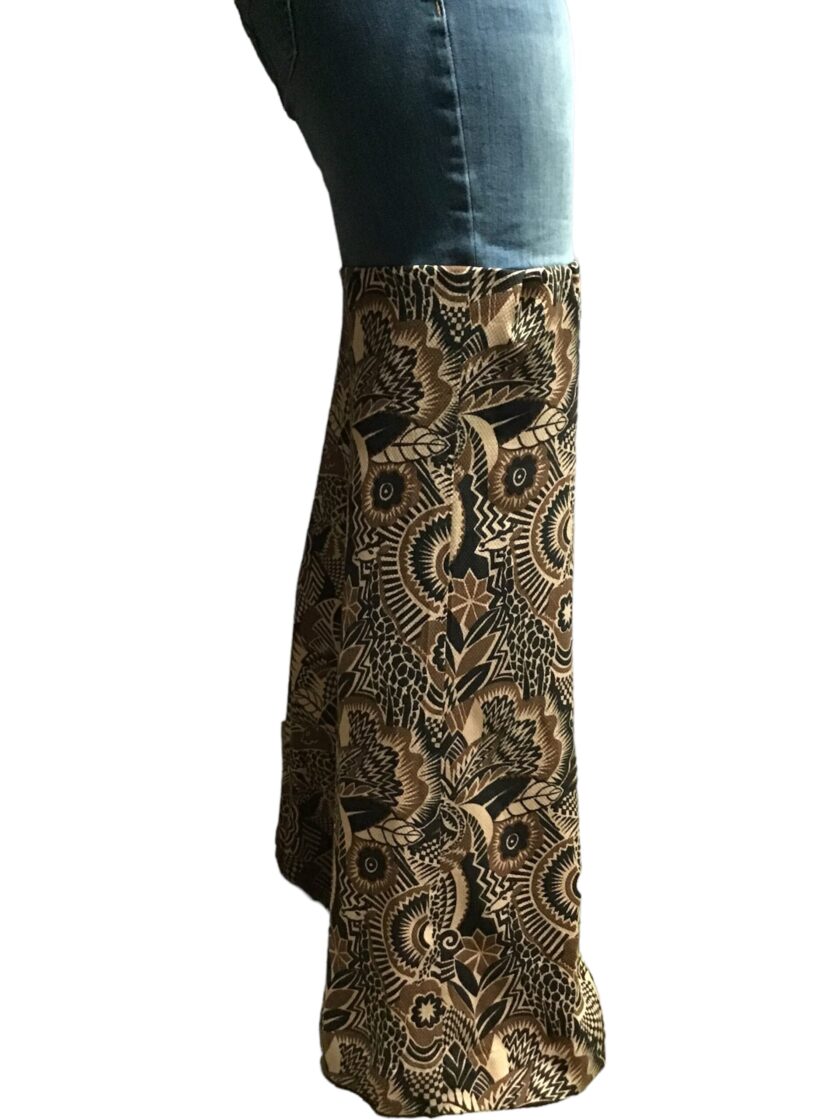 A woman wearing a pair of jeans with a paisley print.
