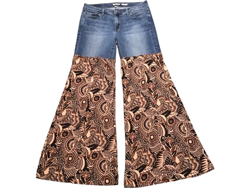 A pair of women's flared jeans with a paisley print.