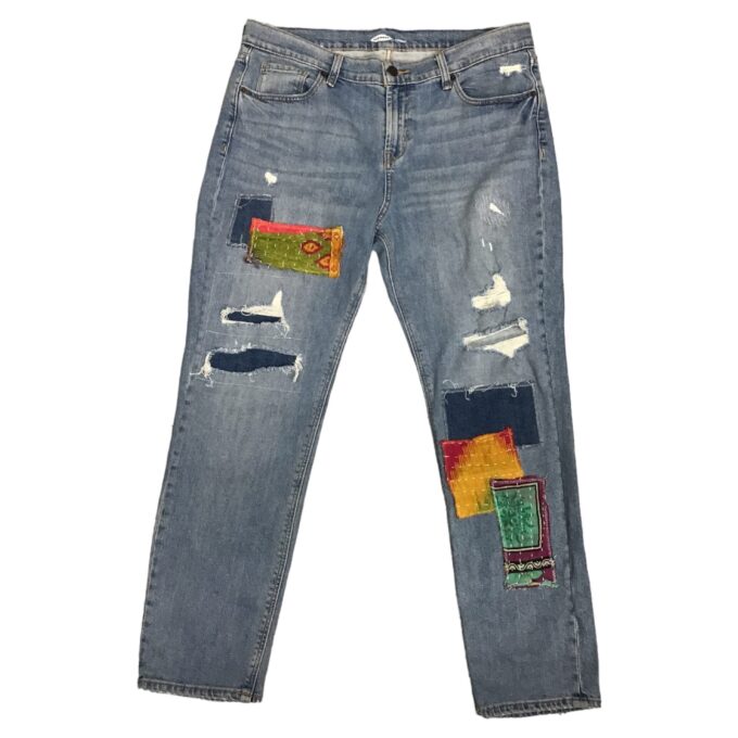 A pair of jeans with patches on them.
