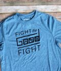 A blue t - shirt that says fight the good fight.